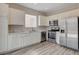 Modern kitchen featuring white cabinets, stainless steel appliances, and marble countertops at 6549 Butterfly Sky St, North Las Vegas, NV 89084