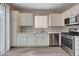 Well-lit kitchen featuring stainless steel appliances, marble countertops, and white cabinetry at 6549 Butterfly Sky St, North Las Vegas, NV 89084