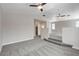 Open loft with vaulted ceiling, ceiling fans, gray carpet, and steps to another area at 6549 Butterfly Sky St, North Las Vegas, NV 89084