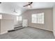 Loft with vaulted ceiling, ceiling fans, gray carpet, windows, and neutral paint at 6549 Butterfly Sky St, North Las Vegas, NV 89084