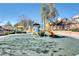 Community playground for children featuring slides and climbing equipment with benches for relaxation at 6549 Butterfly Sky St, North Las Vegas, NV 89084