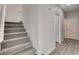 Carpeted staircase with white walls leading to the upper level of the home at 6549 Butterfly Sky St, North Las Vegas, NV 89084