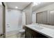 Bathroom with a shower-tub combo, a large mirror, and a dark vanity at 6618 Tangled Vines Ave, Las Vegas, NV 89139