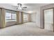Bedroom with large windows and a doorway leading to an ensuite bathroom with tub at 6618 Tangled Vines Ave, Las Vegas, NV 89139