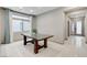 Bright dining room with tile flooring, a natural wood table and natural light at 6618 Tangled Vines Ave, Las Vegas, NV 89139