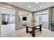 Open-concept dining room adjacent to a living room, offering plenty of natural light at 6618 Tangled Vines Ave, Las Vegas, NV 89139