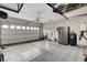View of a two car garage with storage racks and an electric car charger at 6618 Tangled Vines Ave, Las Vegas, NV 89139