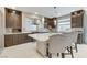 Stylish kitchen with stainless appliances, tile backsplash, and center island with barstool seating at 6618 Tangled Vines Ave, Las Vegas, NV 89139