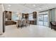 Open-concept kitchen with stainless steel appliances, kitchen island, and sliding glass door to backyard at 6618 Tangled Vines Ave, Las Vegas, NV 89139