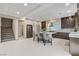 Bright kitchen boasts stainless steel appliances, dark wood cabinets, and a central island with barstool seating at 6618 Tangled Vines Ave, Las Vegas, NV 89139