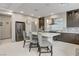 Charming kitchen boasts barstool seating, modern light fixtures, stainless appliances, and a stylish backsplash at 6618 Tangled Vines Ave, Las Vegas, NV 89139