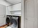 Convenient laundry room features side by side washer and dryer units and overhead shelf at 6618 Tangled Vines Ave, Las Vegas, NV 89139