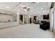 Open-concept space with sleek tile flooring, coffered ceilings, and view to kitchen and dining areas at 6618 Tangled Vines Ave, Las Vegas, NV 89139