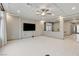 Bright living room with recessed lighting and open concept view to entry and dining area at 6618 Tangled Vines Ave, Las Vegas, NV 89139