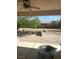 Covered patio overlooking large backyard with desert landscaping, and brick firepit at 6841 Longmeadow Dr, Pahrump, NV 89061