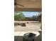 Covered patio overlooking large backyard with desert landscaping, and brick firepit at 6841 Longmeadow Dr, Pahrump, NV 89061