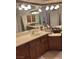 Bathroom featuring double sinks, vanity, and ample mirror space at 6841 Longmeadow Dr, Pahrump, NV 89061