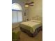 Bedroom featuring a decorative metal bed frame, ceiling fan, and an arched window for natural light at 6841 Longmeadow Dr, Pahrump, NV 89061