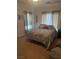 Cozy bedroom with a floral-patterned bedspread and neutral-toned curtains, creating a tranquil retreat at 6841 Longmeadow Dr, Pahrump, NV 89061