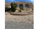 Charming home featuring an arched entry and low maintenance desert landscaping for an appealing and water-wise facade at 6841 Longmeadow Dr, Pahrump, NV 89061