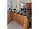 Eat-in kitchen with a large countertop with wood accents and granite countertops at 6841 Longmeadow Dr, Pahrump, NV 89061