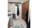 Bright laundry room with tile floor, cabinets and white washer at 6841 Longmeadow Dr, Pahrump, NV 89061