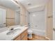Bathroom with a single sink vanity, toilet, and shower-tub combo at 6916 Dorita Ave # 102, Las Vegas, NV 89108