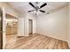 Bedroom with hardwood-look floors with a sliding closet door and doorway to the kitchen at 6916 Dorita Ave # 102, Las Vegas, NV 89108