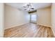 Spacious bedroom with wood-look floors, a ceiling fan, and natural light from a window at 6916 Dorita Ave # 102, Las Vegas, NV 89108