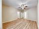 Bright bedroom featuring hardwood-style floors, neutral paint, and multiple doors to adjoining rooms at 6916 Dorita Ave # 102, Las Vegas, NV 89108