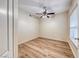 Neutral bedroom with wood-look floors, a ceiling fan, and a bright window with natural light at 6916 Dorita Ave # 102, Las Vegas, NV 89108