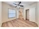 Neutral bedroom with wood-style floors, a ceiling fan, and convenient closet access at 6916 Dorita Ave # 102, Las Vegas, NV 89108