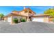 Beautiful two-story home featuring a tile roof, multiple garages, and manicured landscaping at 6916 Dorita Ave # 102, Las Vegas, NV 89108