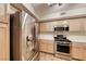 Kitchen featuring a stainless steel refrigerator, modern appliances, neutral cabinets, and tile countertops, ready for culinary adventures at 6916 Dorita Ave # 102, Las Vegas, NV 89108