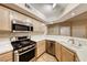 Functional kitchen with stainless steel appliances, ample counter space, and stylish neutral cabinets, offering a practical cooking space at 6916 Dorita Ave # 102, Las Vegas, NV 89108