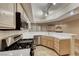 Open concept kitchen featuring modern appliances, tile countertops, ample cabinet space, and an inviting layout at 6916 Dorita Ave # 102, Las Vegas, NV 89108