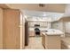 Well-equipped kitchen featuring stainless steel appliances, neutral cabinets, tile countertops, and a cozy breakfast bar at 6916 Dorita Ave # 102, Las Vegas, NV 89108