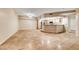 Bright, open living area showcasing tile floors, neutral walls, and a breakfast bar to the kitchen at 6916 Dorita Ave # 102, Las Vegas, NV 89108
