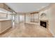 Bright living room featuring a fireplace, neutral colors, tile flooring, and an open layout, providing a comfortable and inviting atmosphere at 6916 Dorita Ave # 102, Las Vegas, NV 89108