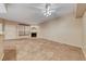 Spacious living room featuring tile floors, a fireplace, and a ceiling fan with ample lighting at 6916 Dorita Ave # 102, Las Vegas, NV 89108
