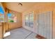 Covered porch showcasing a security gate, a decorative welcome mat, and neutral stucco at 6916 Dorita Ave # 102, Las Vegas, NV 89108