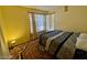 Cozy bedroom with neutral paint and a window providing natural light, carpeted floors at 6955 Grassy Knoll St, Las Vegas, NV 89147