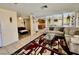 Open-concept living room with tile flooring, neutral paint, and lots of natural light at 6955 Grassy Knoll St, Las Vegas, NV 89147