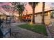 View of backyard featuring an outdoor kitchen, above ground pool, mature palms and lush green grass at 711 Sari Dr, Las Vegas, NV 89110