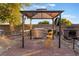 Outdoor kitchen with stainless steel grill, bar seating, and brick-paved area, great for barbecues at 711 Sari Dr, Las Vegas, NV 89110