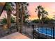 Backyard view showcases the pool with mature palm trees and an entertainment area at 711 Sari Dr, Las Vegas, NV 89110