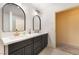 Bathroom featuring modern double sink vanity with black cabinets, white countertop, and stylish gold faucets at 711 Sari Dr, Las Vegas, NV 89110