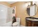 Bathroom with vanity, shower, toilet, and decorative mirror at 711 Sari Dr, Las Vegas, NV 89110