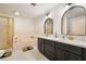 Bathroom featuring double vanities, gold hardware, and a separate shower at 711 Sari Dr, Las Vegas, NV 89110