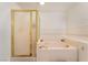 Bright bathroom featuring a tub with gold fixtures and a standing shower with gold trim at 711 Sari Dr, Las Vegas, NV 89110